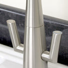 Silver two-handle high-arc kitchen faucet.