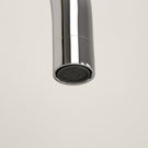 Close-up of a chrome faucet head.