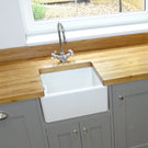 Wall-mounted white ceramic bathroom sink above counter.