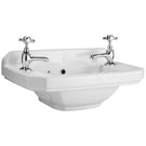 White ceramic wash basin with twin pillar taps