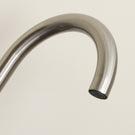 Polished chrome curved faucet spout.