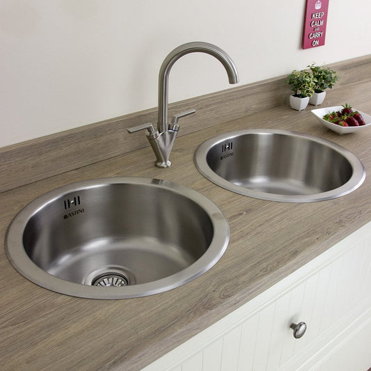Stainless steel double bowl sink with two taps