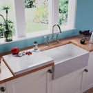 White ceramic apron-front kitchen sink.