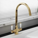 Gold kitchen faucet installed on countertop