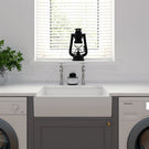 White fireclay apron-front sink with a silver single-handle faucet
