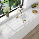 Silver two-handle faucet with a long spout.