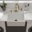 White sink with a gold-toned high-arc faucet.