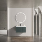 Round mirror above black vanity with basin