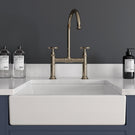 White farmhouse sink with rose gold kitchen tap