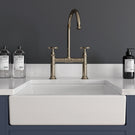 White farmhouse sink with rose gold kitchen tap