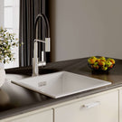 Modern kitchen sink with faucet and fruit bowl on countertop