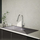 Modern kitchen sink with faucet against a patterned wall