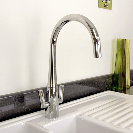 Silver kitchen faucet with a high curved spout.
