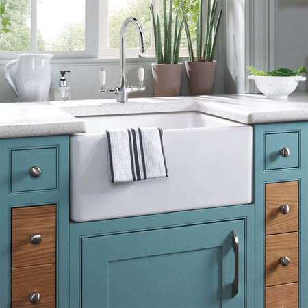 Blue farmhouse sink with chrome faucet