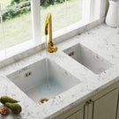 White double bowl ceramic farmhouse sink with gold mixer tap