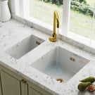 White kitchen sink with gold tap faucet