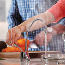 Plumber repairing pipes with wrench and gloves