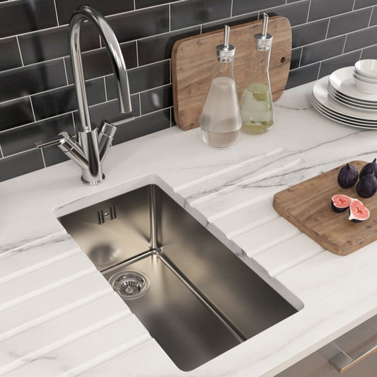 Worker using laptop for bathroom planning