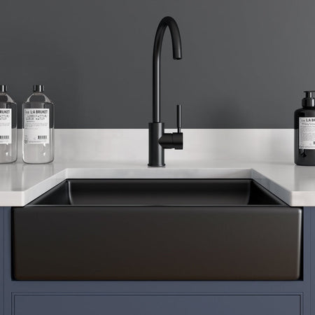 Black single-basin sink with a black faucet.