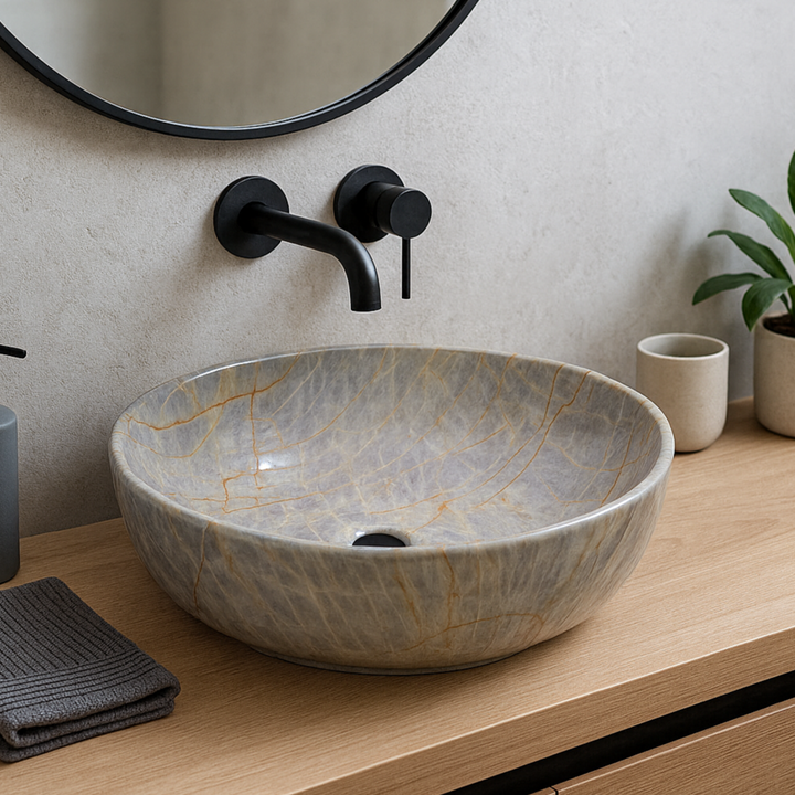 Bathroom vanity with a stone-patterned sink, black faucet, and decorative elements.