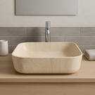 Beige rectangular sink on a wooden countertop with a tiled wall background