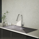 Modern kitchen sink with faucet against a patterned wall